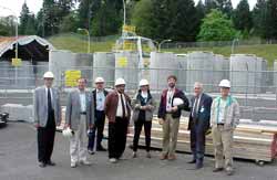 Lithuanian and Armenian nuclear personnel pose with hosts in front of spent fuel dry storage area at Trojan NPP in Oregon.